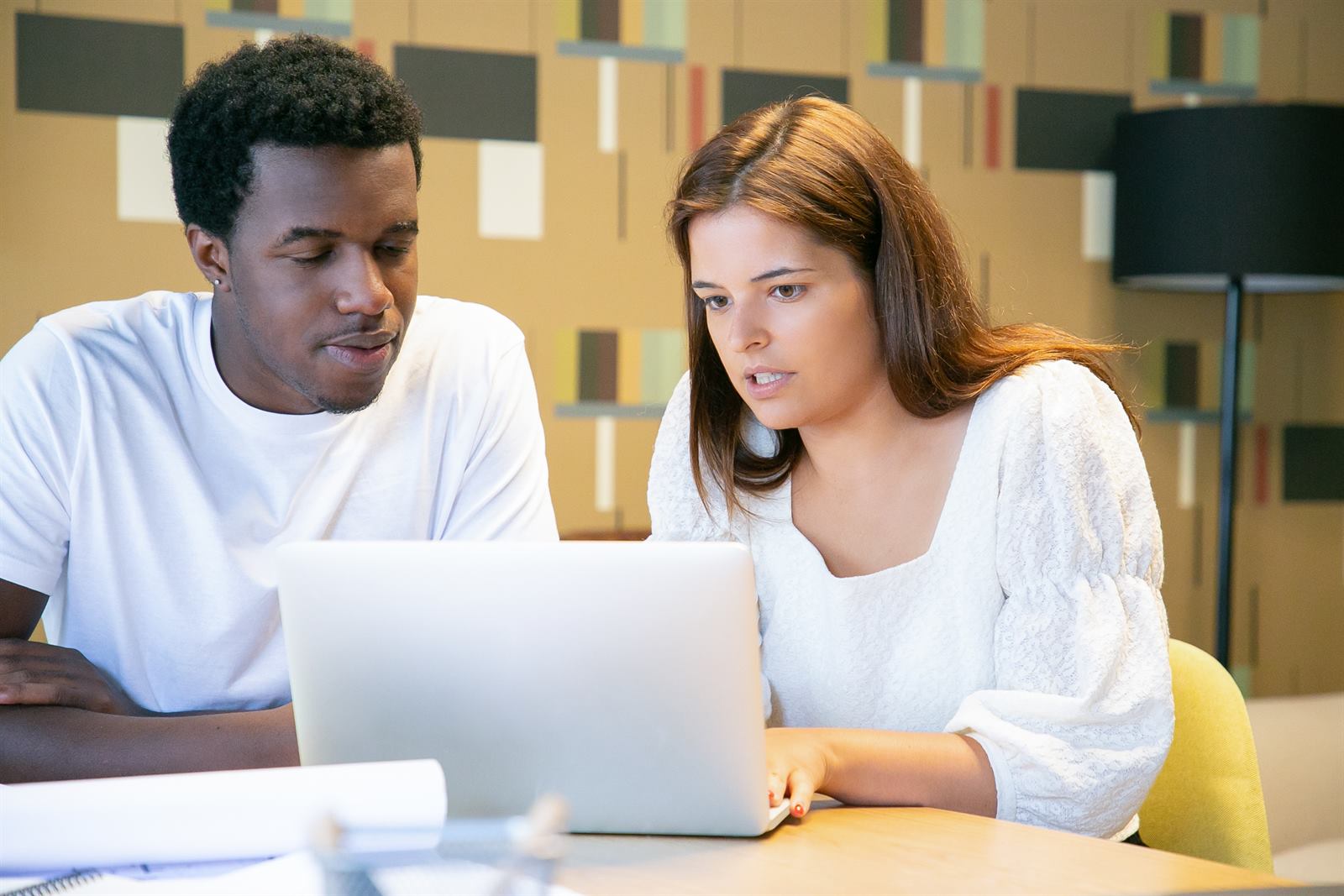 Diverse learners studying together on a laptop